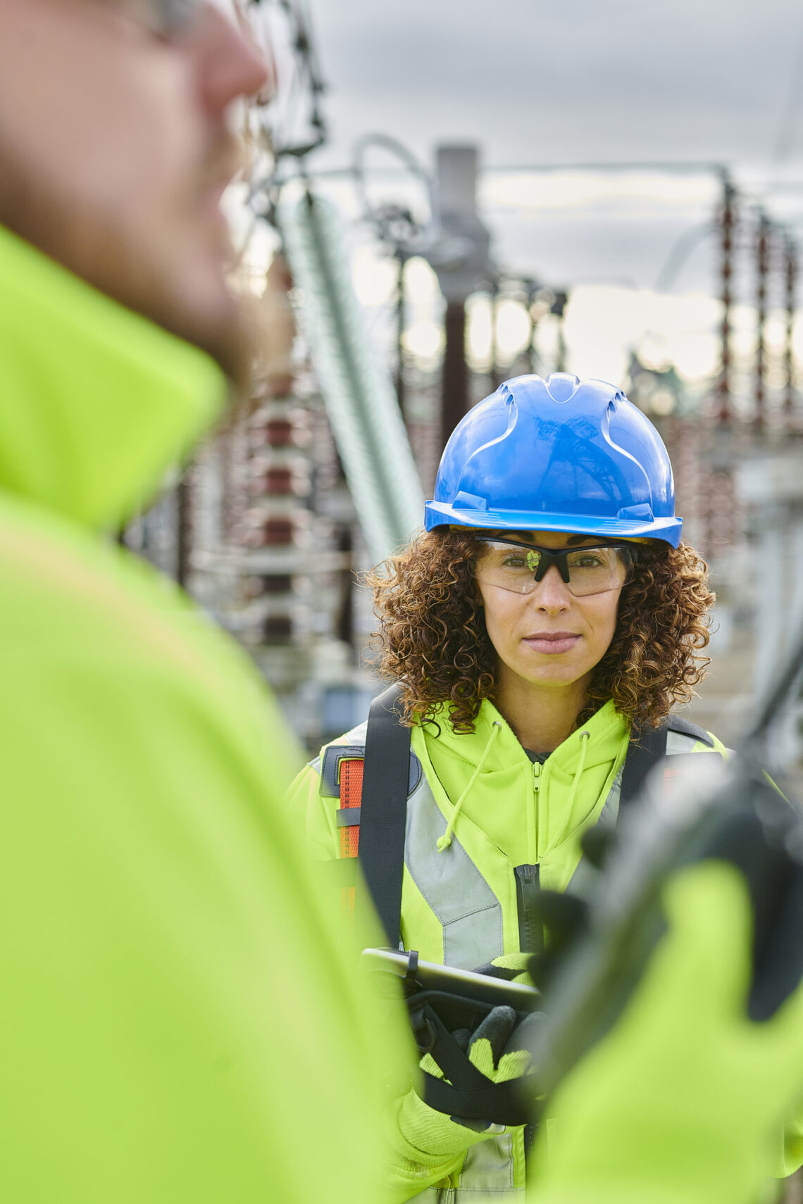 Safety professional in high-visibility PPE during a discussion at an operational site